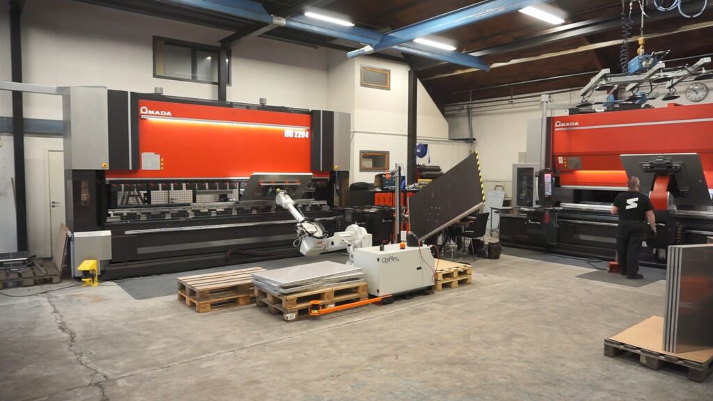 OpiFlex tending an Amada while operator works beside small